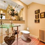 Elegant bathroom with glass sink and floral arrangement