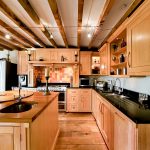 Modern kitchen with wooden cabinets and appliances.