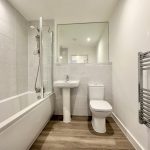 Modern bathroom with shower and towel rail