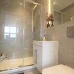 Modern bathroom with glass-enclosed shower and vanity