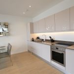 Modern kitchen with dining area and abstract art