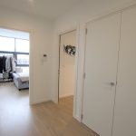 Bright hallway with bedroom in view.
