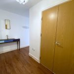 Modern hallway with wooden floor and doors