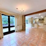 Spacious kitchen dining area with tiled floor.