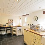 Bright kitchen with modern appliances and wooden countertops.