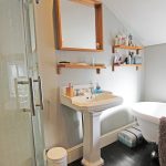 Modern bathroom with shower and freestanding bathtub.