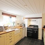 Bright kitchen with rustic decor and modern appliances.