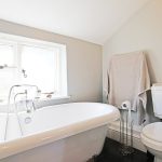 Bright bathroom with bathtub and toilet