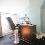 Home office with desk, chair, and computer.