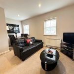 Modern living room with black sofa and TV
