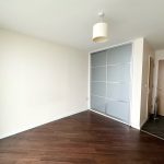 Minimalist room with wooden floor and sliding wardrobe.