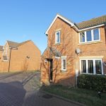 Two-storey detached brick houses in a residential area.