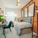Stylish bedroom with abstract decor and desk.