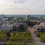 Aerial view of modern office buildings and greenery.