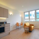 Modern studio flat with kitchen and lounge area.