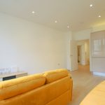 Modern open-plan living room with yellow sofa