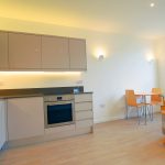 Modern kitchen and dining area with sofa