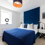 Modern bedroom with blue accents and decor