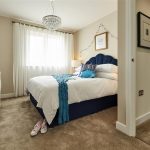 Cosy bedroom with blue and white decor.