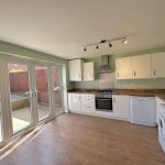 Modern kitchen with patio doors and appliances