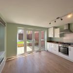 Modern kitchen with garden view and wooden floor