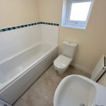 Small bathroom with bathtub, sink, and toilet.