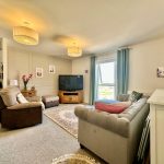 Cosy living room with modern decor and TV.