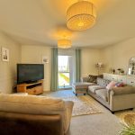 Cosy living room with sofas and TV.