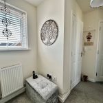 Cozy corner with window and decorative wall items.
