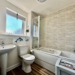 Modern bathroom with bathtub and decor.