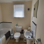 Modern bathroom with bath, toilet, and sink