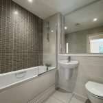 Modern bathroom with bathtub, sink, and toilet
