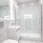 Modern marble-tiled bathroom with sleek shower and vanity