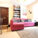 Cosy living room with pink sofa.