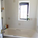 Bathroom with bathtub and window view.