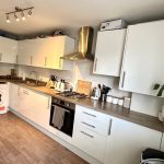 Modern kitchen with appliances and white cabinets