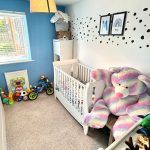 Colourful nursery with toys and cot.