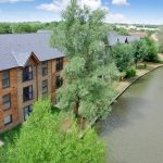 Wooden apartments along a peaceful canal.
