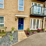 Modern brick house with garden and blue door