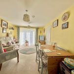 Cosy living room with yellow walls and furniture.