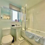 Modern bathroom with shower and bathtub.