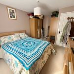 Cosy bedroom with blue-patterned bedspread