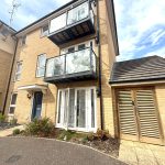 Modern two-storey brick house with balconies.