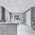 Modern kitchen with island and dining area.