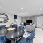 Modern living room with dining area and blue chairs.