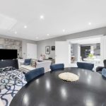 Modern living room with open-plan kitchen view.