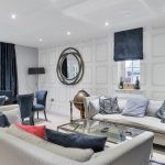 Modern living room with sofas, chairs, and table.
