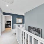 Modern hallway with a blue accent wall.