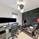 Gaming setup with racing simulator in home office.