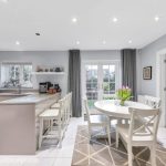 Modern kitchen with dining table and island.